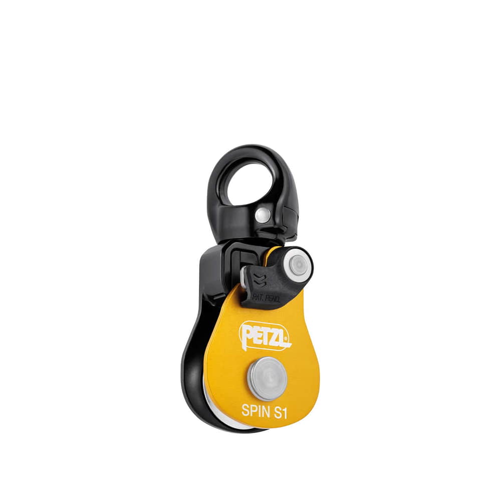 Petzl Spin S1, gelb-schwarze Umlenkrolle mit Metallring oben und weißem Knopf auf gelber Platte