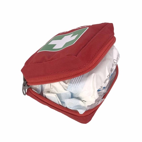 Rotes Tatonka First Aid XS Set geöffnet, Inhalt mit weißen und blauen Verpackungen sichtbar