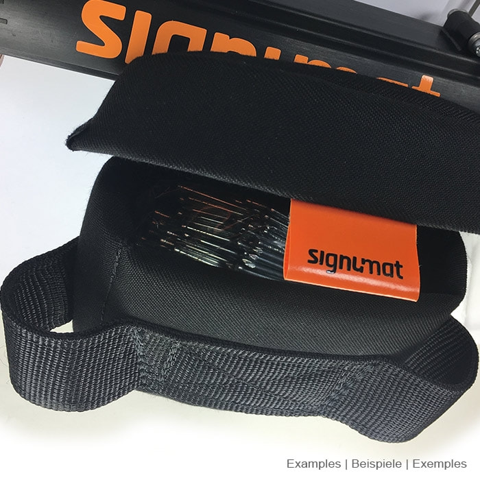 Schwarzes gepolstertes Fach mit orangefarbenem signumat-Label und darin sichtbaren Metallstiften
