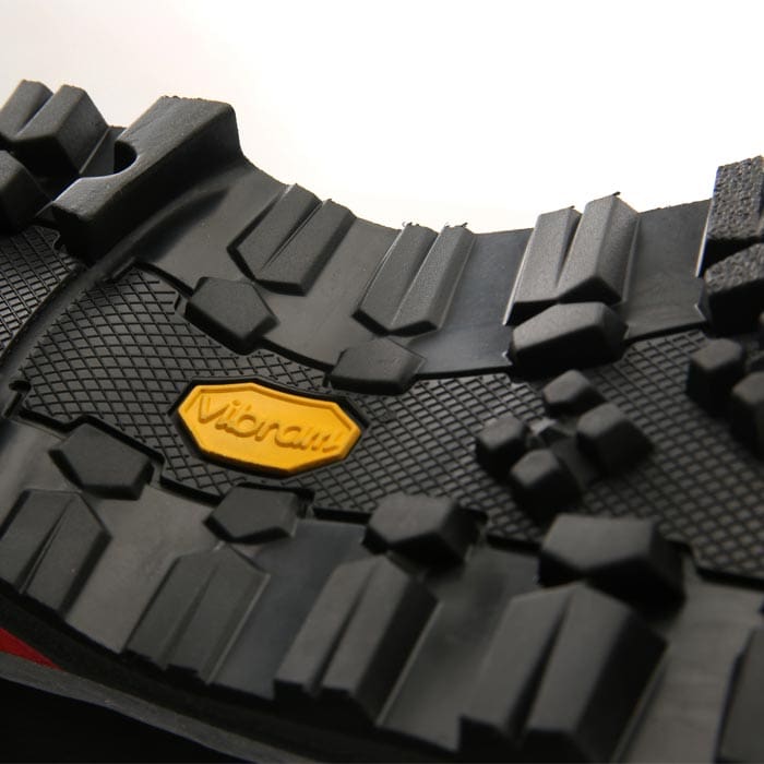 Nahaufnahme der schwarzen Profilsohle mit gelbem Vibram-Logo