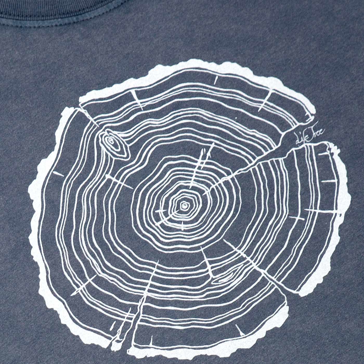 Nahaufnahme des weißen Baumstammschnitt-Aufdrucks auf einem dunkelblauen T-Shirt, Produktname Treeslice